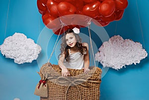 Small cute girl flying on red heart balloons Valentines day