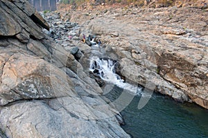 A small dam area where water is falling between the rocks