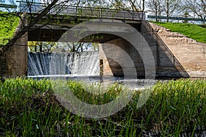 Small dam on a small river in the countryside in springtime