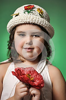 Small dark-haired girl with red poppy