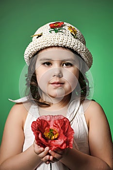 Small dark-haired girl with red poppy