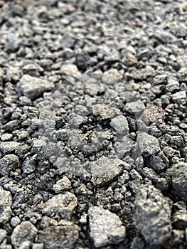 Small dark stones on a rocky gravel path