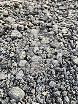 Small dark stones on a rocky gravel path