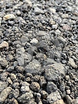 Small dark stones on a rocky gravel path