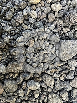 Small dark stones on a rocky gravel path