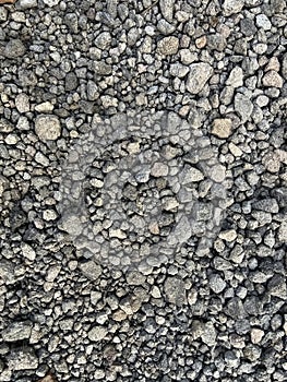 Small dark stones on a rocky gravel path