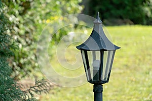 A small decorative lantern in the garden. Lighting of the infield. Electric street lighting