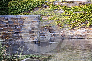 A small decorative waterfall in the garden. Landscape design