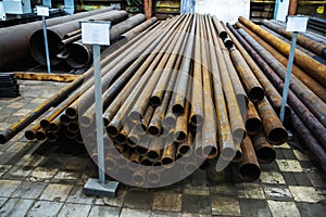 Small diameter metal pipes in the warehouse of the plant. Manufacture and sale of steel products. Foreground