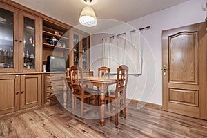 Small dining room in a home with matching table and chairs, wooden floors