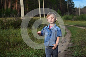 Small dirty child walkon a path