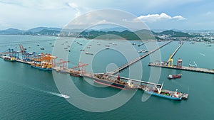 small distribution port in sea and pedestrian bridge to conect between islands and oil tankers ship floating in sea