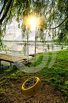 Small Dock and Boat at the lake and wonderful tree with swing for kids