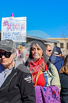 Small dog in Pink hat yawning surrounded by people in hats at Womens march in Tulsa Oklahoma 1-20-2017