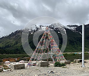 Small dome at the foot of the mountains with Buddhist Tibetan prayer flags