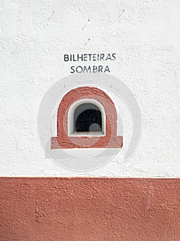 small domed window on the facade of the bullring belonging to the sale of tickets to the sun, shade in the village of Coruche