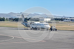 A small domestic Air New Zealand plane on the runway at Christchurch International Airport