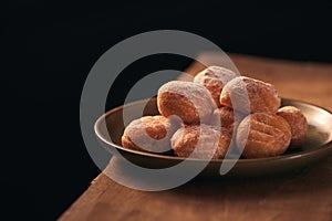 Small donuts with powdered sugar selective focus