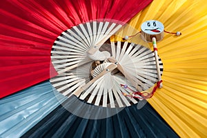 Small drum on colorful paper fans background