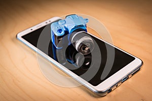 Small DSLR camera toy over a Smartphone.