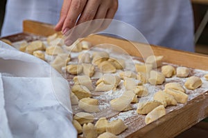 Small Dumplings on Wooden Board with Flour: Italian Gnocchi Past