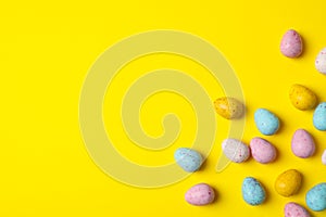 Small Easter eggs on yellow background