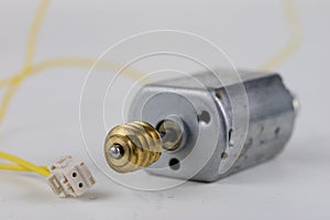 Small electric motor on a white workshop table. Electric drive u