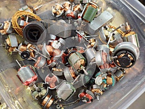 Small electric motors in container showing windings and shafts