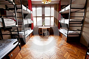 Small empty bedroom with bunk beds inside a hostel for youth, students and tourists