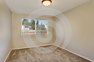 Small empty room interior with beige carpet floor