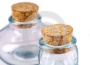 The small empy glass with a cork isolated on a white background
