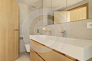 Small entrance hallway to a modern designed bedroom with custom-made built-in wardrobe with light oak wooden doors and matching