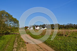 Small family house on green field with blue sky