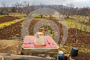 Small farm in Croatia vegetable field, orchard, well in spring