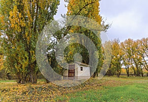 Small farm tool shed abandoned in autumn