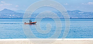 A rescue fast motor boat with a powerful motor patrols the coastline of the Gulf of Corinth photo