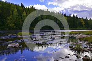 Small fast rifts on the Ural mountain river Usva in the area of the Stolby stone