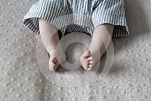 Small feet of barefoot little baby.