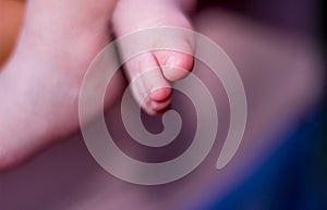 Small feet of newborn