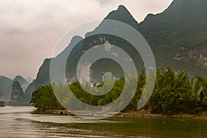 Small ferries at steps in front of karst mountains along Li River in Guilin, China