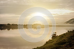 Small ferry of the villagers in international Mekong River. Chiang Khan, Loei, Thailand. at sunset.