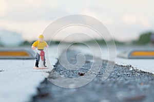 Small figure of a man digging street