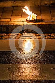 Small fire reflecting on zebra crossing