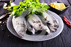 small fish on plate with spice and herb