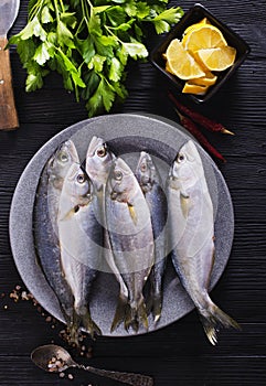 small fish on plate with spice and herb