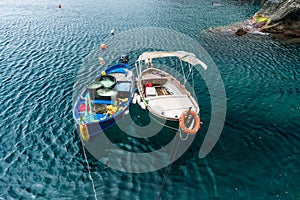 Small fisherman boats in mediterranean sea at Manarola pier, Cinque Terre, Italy