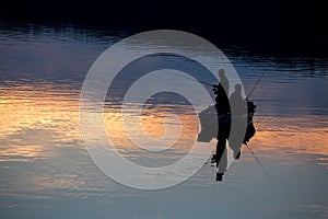 Small fishermen ship on a sundown lake