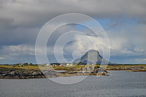 Small fishermen village on island in Helgeland archipelago in the Norwegian sea on sunny summer morning