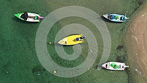 Small Fishing Boat anchored in a shallow lagoon, Aerial view.