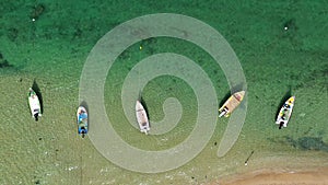 Small Fishing Boat anchored in a shallow lagoon, Aerial view.